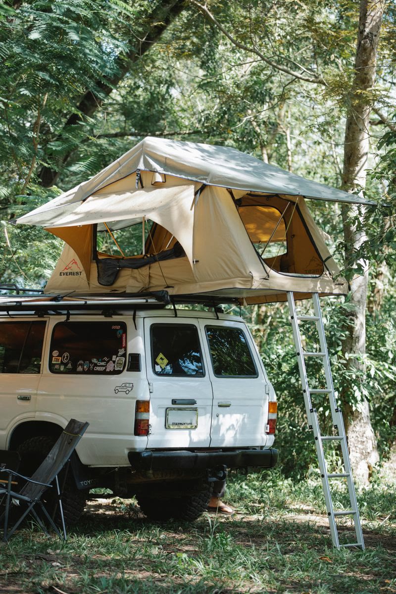 SUV camping setup in the woods