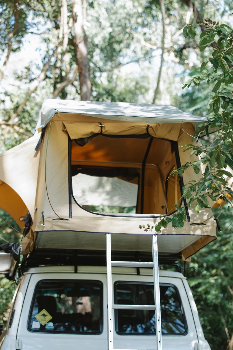 SUV parked for camping among trees